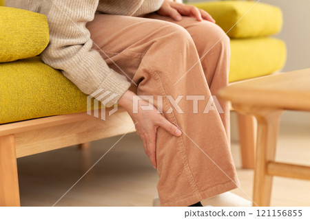 Middle-aged to senior women suffering from pain in their calves 121156855