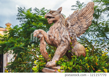 sculpture of a mythological bird in a green garden sculpture of a mythological bird in a green garden 121157770