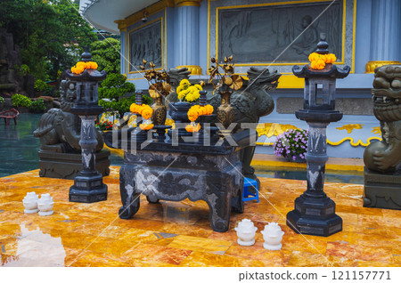 The Asian altar, with colorful floral arrangements on the territory of the Vietnamese temple, symbolizes devotion and spirituality The Asian altar, with colorful floral arrangements on the territory of the Vietnamese temple, symbolizes devotion and spirituality 121157771