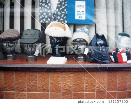 Glasses and hats in a British shop window 121157800