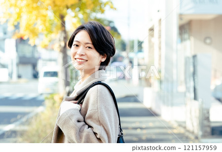 Woman wearing a coat outdoors Woman wearing a coat outdoors 121157959