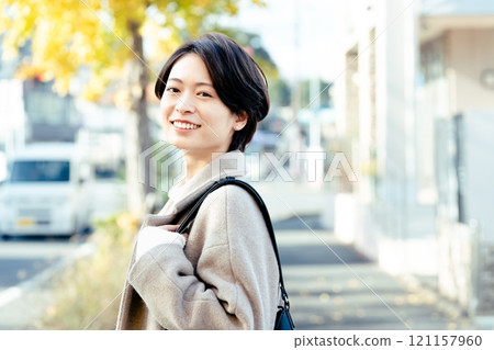 Woman wearing a coat outdoors Woman wearing a coat outdoors 121157960
