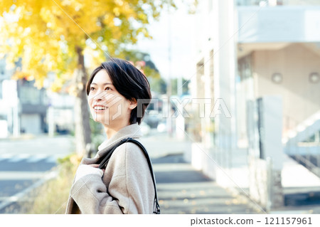 Woman wearing a coat outdoors Woman wearing a coat outdoors 121157961