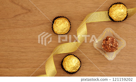 Gold ribbon image of chocolate gift that will be appreciated as a Valentine's Day or Christmas gift 121159202