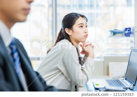 Business person talking with colleague in office 121159383