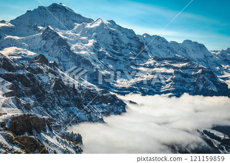 Jungfrau peak above the misty valley, Lauterbrunnen, Switzerland 121159859