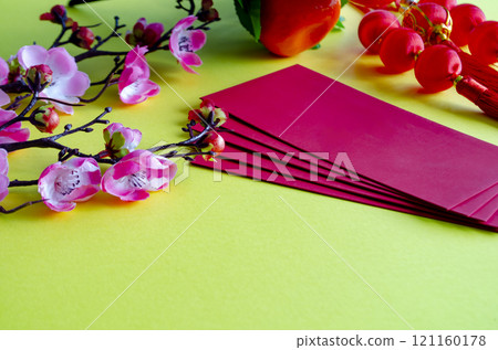 Chinese New Year decoration with red packets on yellow cover background with customizable space for text. Chinese New Year celebration concept 121160178