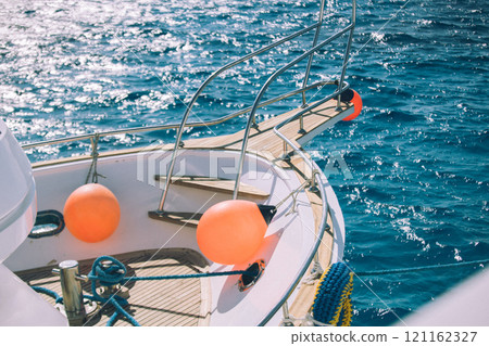 Coral yacht fender against dark sea. Boat trip and vacation concept 121162327