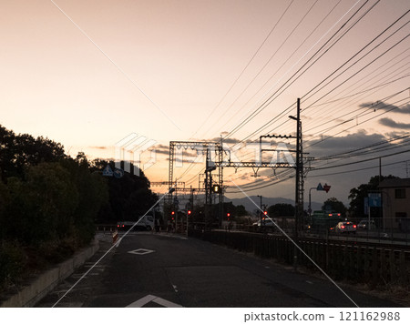 Early winter 2024, around Nara Kintetsu Yamato-Saidaiji Station before sunrise, railroad tracks stretching eastward and the morning sky, horizontal composition 121162988