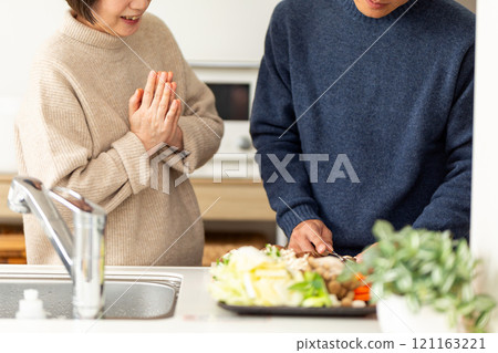 A middle-aged couple preparing hotpot in the kitchen A middle-aged couple preparing hotpot in the kitchen 121163221