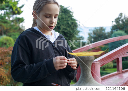 Curious child girl on playground. Kids play outdoor. 121164106