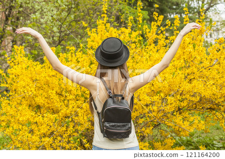 Happy traveler woman travel in flower garden outdoors Happy traveler woman travel in flower garden outdoors 121164200