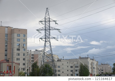 High voltage power lines are located near residential buildings.  121164617