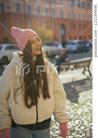 A Young Woman Relishing a Bright and Sunny Day While Relaxing in a Beautiful Park A Young Woman Relishing a Bright and Sunny Day While Relaxing in a Beautiful Park 121164690