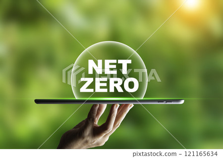 Hand holding tablet Net Zero text on it. natural garden background, wallpaper for net zero emissions concept, carbon footprint to limit global warming and climate change. earth day ,friendly energy, 121165634