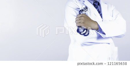 Close-Up of a Doctor Holding a Stethoscope on white background. Close-Up of a Doctor Holding a Stethoscope on white background. 121165638