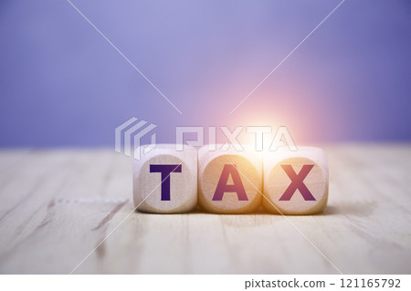 Tax increase concept. Tax icon in wood on wooden floor background. Tax increase concept. Tax icon in wood on wooden floor background. 121165792