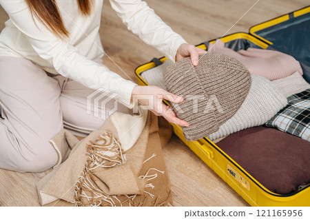 Hand, woman and suitcase for travel, adventure and vacation before leaving for winter holidays Hand, woman and suitcase for travel, adventure and vacation before leaving for winter holidays 121165956