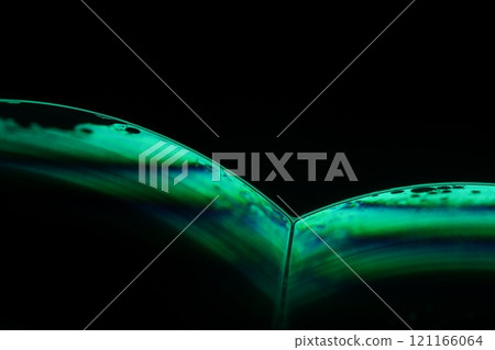 Green liquid phenomenal minimalistic structure, cold green liquid flow on the dark background, colourful abstract, surrealistic art, line of light 121166064