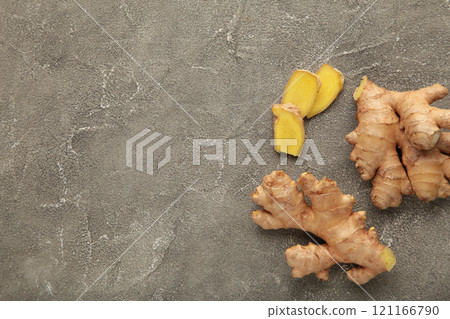 Fresh ginger with sliced on grey background Fresh ginger with sliced on grey background 121166790