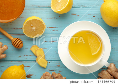 Ginger tea with lemon and honey on blue wooden background. Top view. 121166795