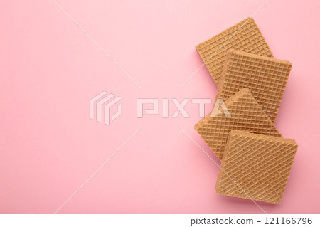 Square chocolate wafer biscuits on pink background. 121166796