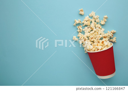 Delicious popcorn on light blue background. Space for text Delicious popcorn on light blue background. Space for text 121166847