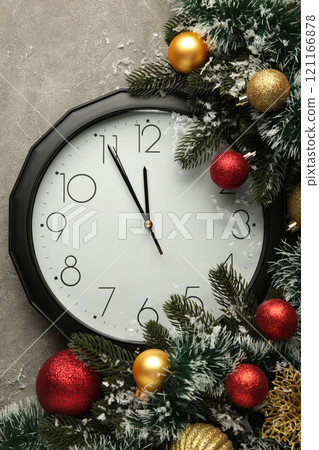 Christmas clock with christmas decoration on grey background. Happy new year concept. Vertical photo. Christmas clock with christmas decoration on grey background. Happy new year concept. Vertical photo. 121166878