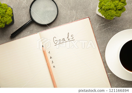 My Goals as memo on notebook with cup of coffee on grey background. 121166894