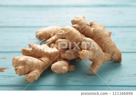 Fresh ginger on a blue background. Healthy food Fresh ginger on a blue background. Healthy food 121166898