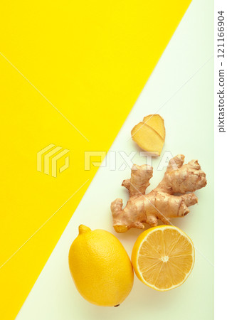 Lemon and ginger on white and yellow background. Vertical photo Lemon and ginger on white and yellow background. Vertical photo 121166904