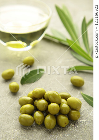 Olive with oil on grey background. Vertical photo Olive with oil on grey background. Vertical photo 121166922