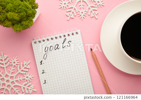 My Goals as memo on notebook with christmas decoration on pink background. My Goals as memo on notebook with christmas decoration on pink background. 121166964