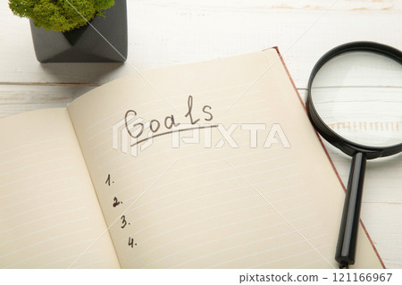 My Goals as memo on notebook with magnifying glass on grey wooden background. 121166967