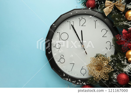 Christmas clock with christmas decoration on blue background. Happy new year concept. 121167000