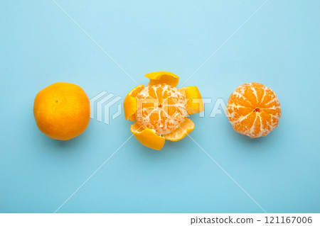 Fresh peeled mandarin orange on blue background. Fresh peeled mandarin orange on blue background. 121167006