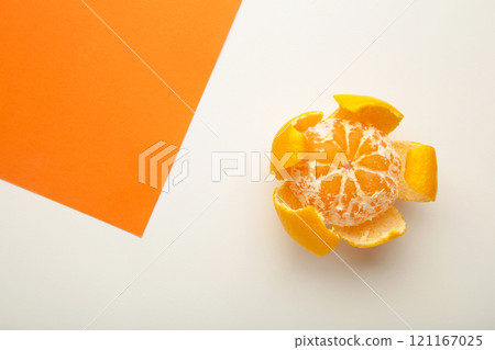 Fresh peeled mandarin orange on colorful background. 121167025