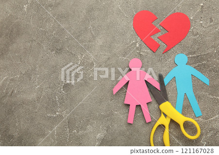 Scissors cutting paper cut of family on pink background. Broken family concept, divorce Scissors cutting paper cut of family on pink background. Broken family concept, divorce 121167028