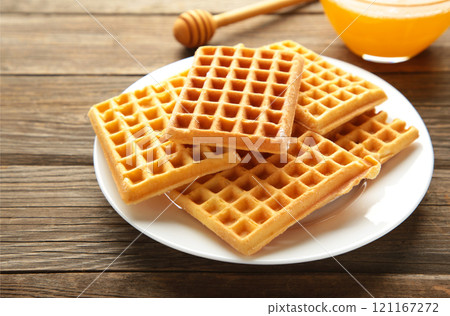 Belgian waffles. Belgian waffles with honey and milk. Freshly baked Belgian waffles. 121167272