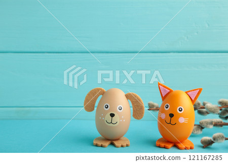 Easter holiday concept with cute handmade eggs, dogs and cat on blue background. 121167285