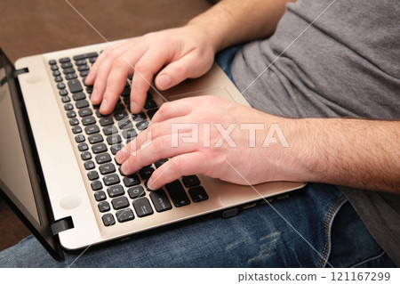 Businessman working at home with a laptop on sofa. 121167299