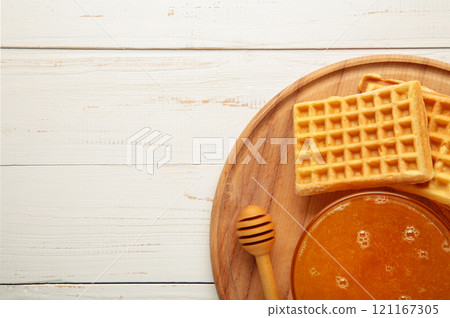 Belgian waffles. Belgian waffles with honey and milk. Freshly baked Belgian waffles. 121167305