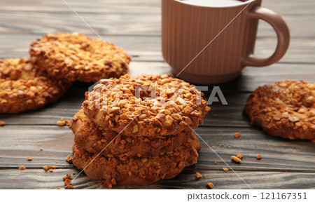 Peanut cookies with tea on brown background. Bakery products. 121167351