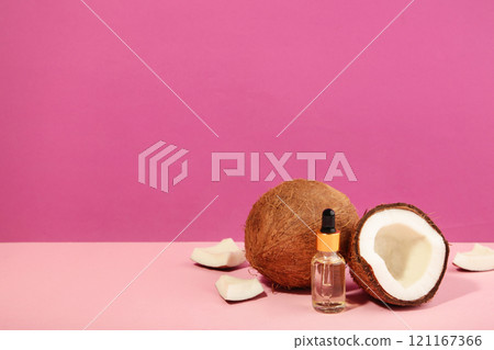 Coconut oil with coconut on pink background. Top view 121167366