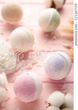 Aroma bath bombs in spa composition with dry flowers and salt on pink background. Vertical photo. 121167370