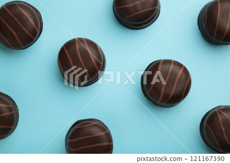 Chocolate sweets on a blue background. Biscuit Chocolate sweets on a blue background. Biscuit 121167390