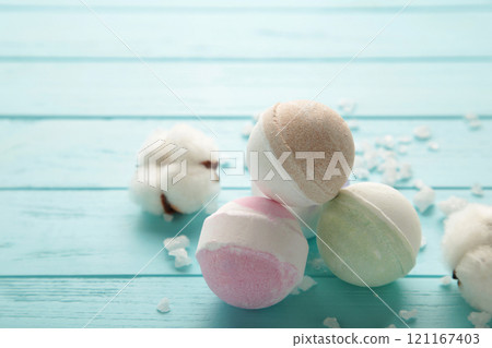Aroma bath bombs in spa composition with dry flowers and salt on blue background. Aroma bath bombs in spa composition with dry flowers and salt on blue background. 121167403