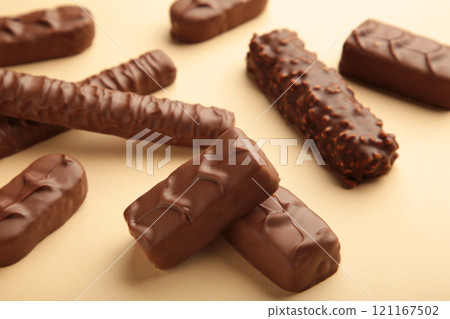 Mix of chocolate bars on beige background with copy space. Top view. 121167502