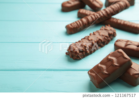 Mix of chocolate bars on blue wooden background. Top view. 121167517
