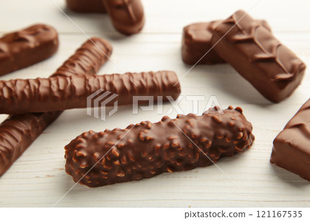 Mix of chocolate bars on white wooden background. Top view. Mix of chocolate bars on white wooden background. Top view. 121167535